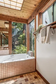a kitchen with stainless steel appliances granite countertop a sink a stove a refrigerator and island with wooden floor