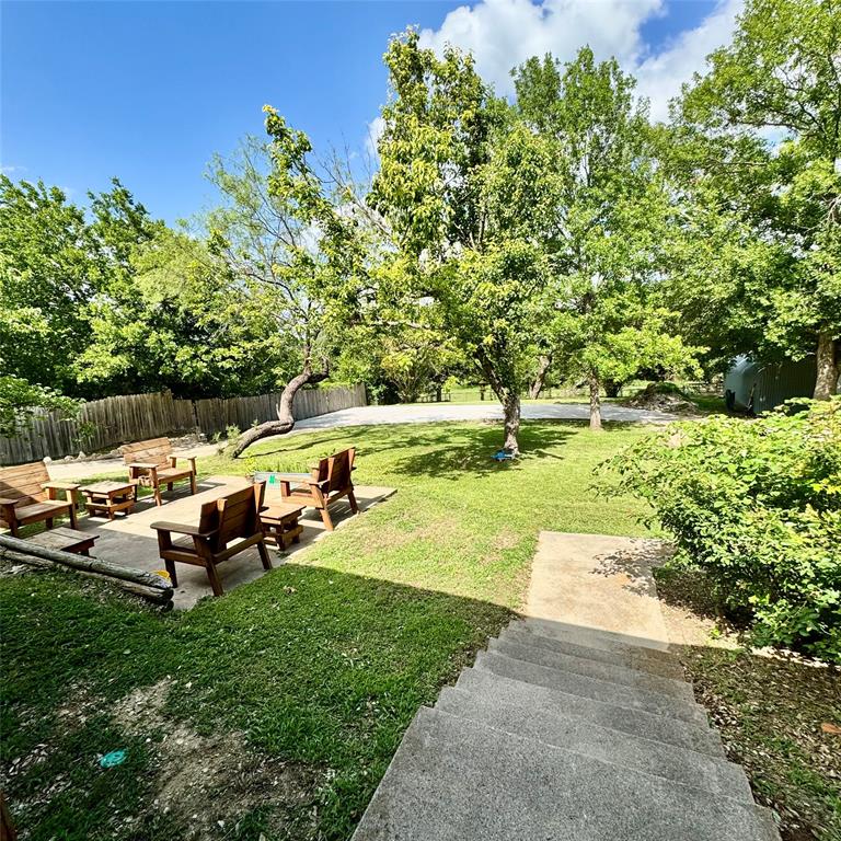104 Advance Road Weatherford, TX 76088 - Photo 27 of 38 a view of a lake with a yard and sitting area