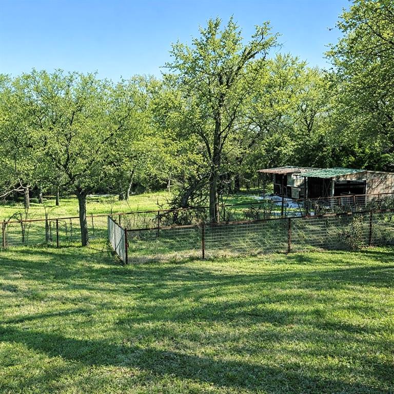 104 Advance Road Weatherford, TX 76088 - Photo 29 of 38 a swimming pool with trees in the background