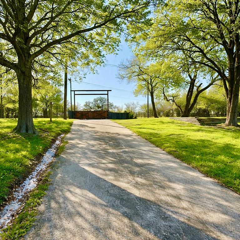 104 Advance Road Weatherford, TX 76088 - Photo 31 of 38 a front view of a house with a yard and an trees