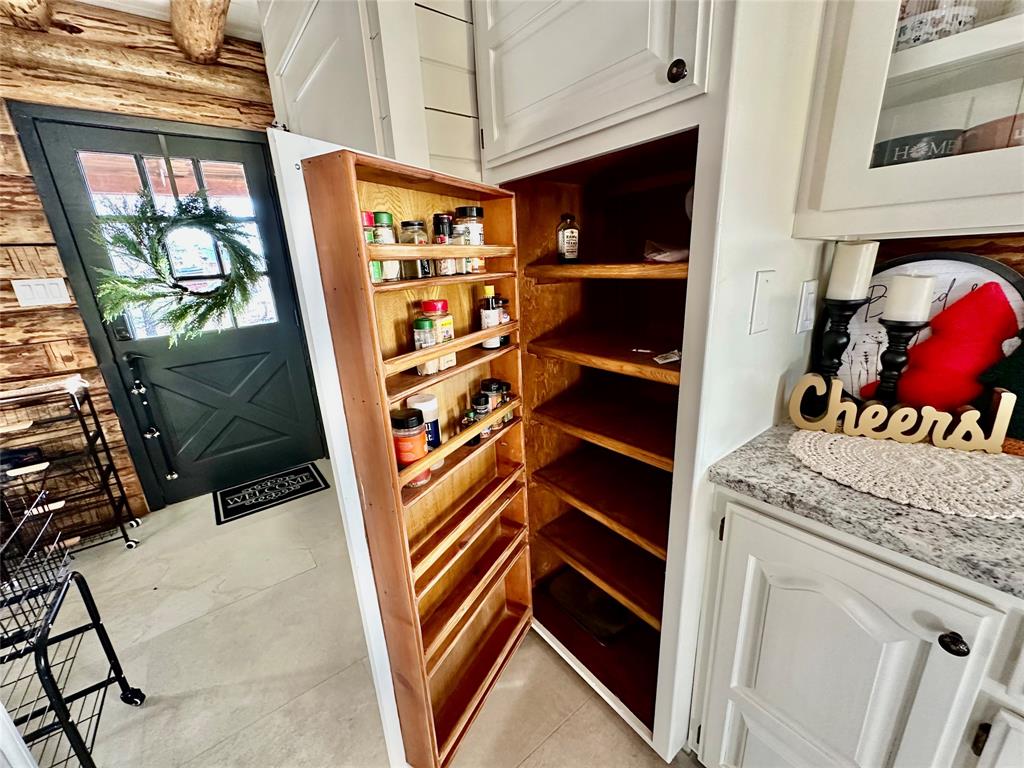 104 Advance Road Weatherford, TX 76088 - Photo 33 of 38 a view of walk in closet with clothes and shoes