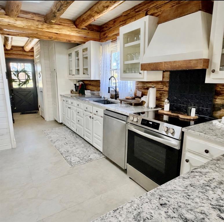 104 Advance Road Weatherford, TX 76088 - Photo 4 of 38 a kitchen with stainless steel appliances granite countertop a stove a sink and a microwave