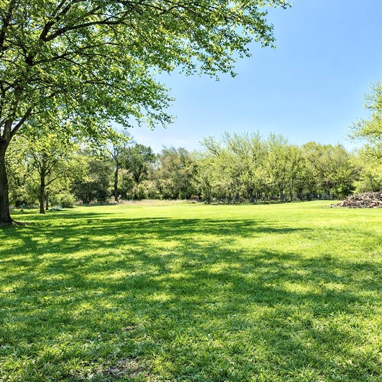 104 Advance Road Weatherford, TX 76088 - Photo 5 of 38 a view of a green field with wooden fence