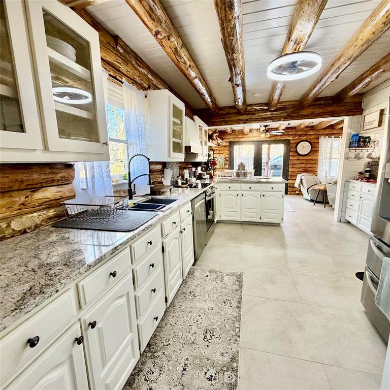 104 Advance Road Weatherford, TX 76088 - Photo 7 of 38 a large white kitchen with stainless steel appliances granite countertop lots of counter top and a stove