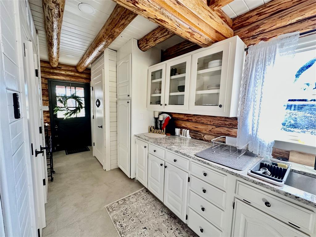 104 Advance Road Weatherford, TX 76088 - Photo 8 of 38 a kitchen with granite countertop a sink and cabinets