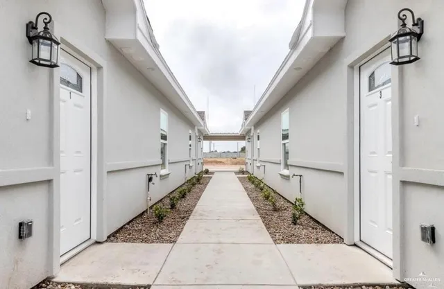 a view of a hallway with the white walls and railing