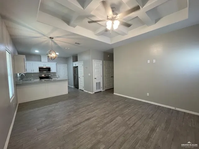 a view of kitchen with refrigerator sink and cabinets