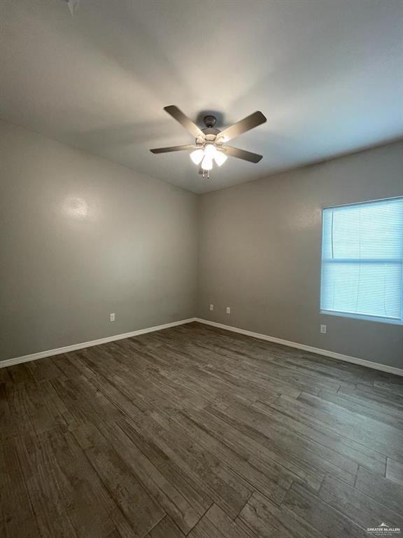 1809 Redbud Lane, Unit 3 Weslaco, TX 78596 - Photo 8 of 8 an empty room with a window and a ceiling fan