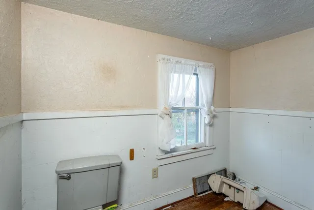 a view of a room with wooden floor and windows