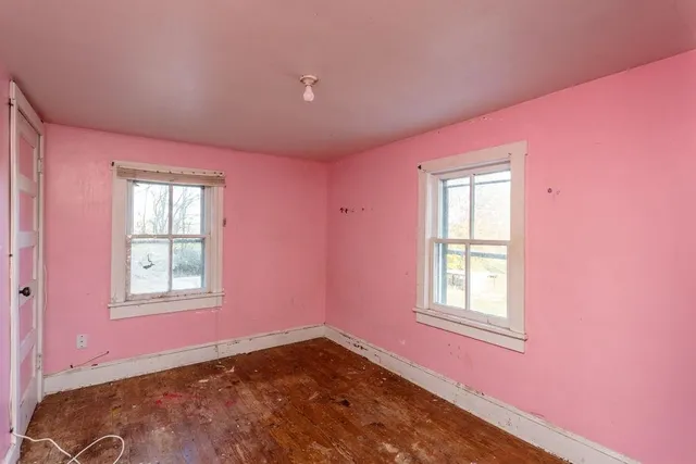 a view of a house with a big yard plants and large trees