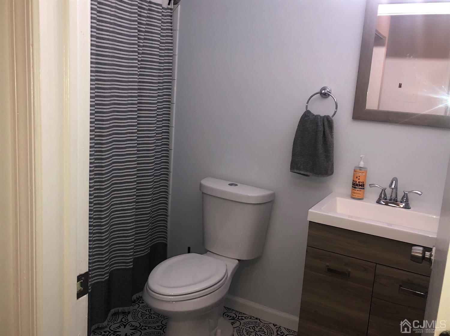 233 Edpas Road New Brunswick, NJ 08901 - Photo 13 of 18 a bathroom with a toilet sink and mirror
