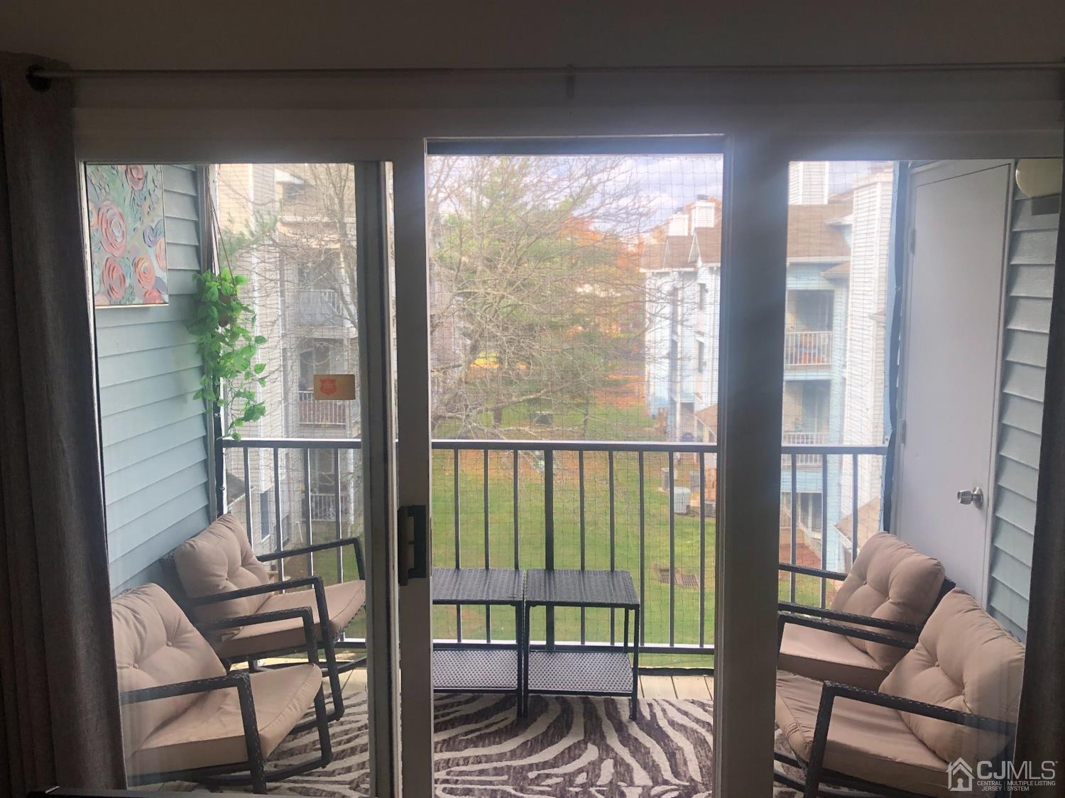 233 Edpas Road New Brunswick, NJ 08901 - Photo 9 of 18 a view of a room with furniture wooden floor and a porch