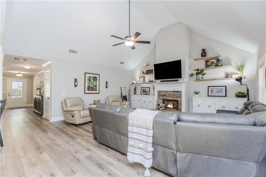 43 Water Lily Way Pendergrass, GA 30567 - Photo 11 of 71 a living room with furniture a fireplace and a flat screen tv