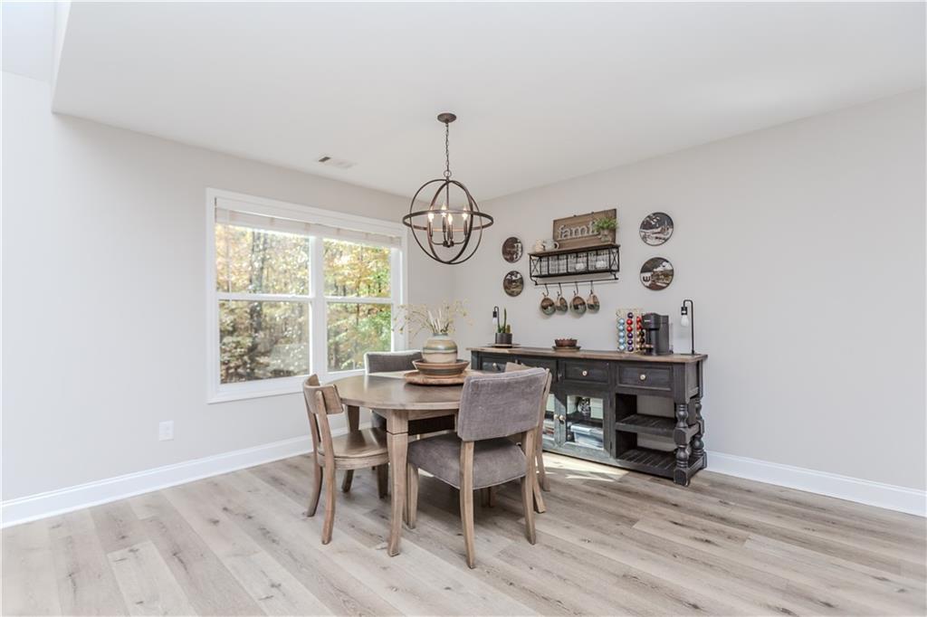 43 Water Lily Way Pendergrass, GA 30567 - Photo 13 of 71 a view of a dining room with furniture window and wooden floor