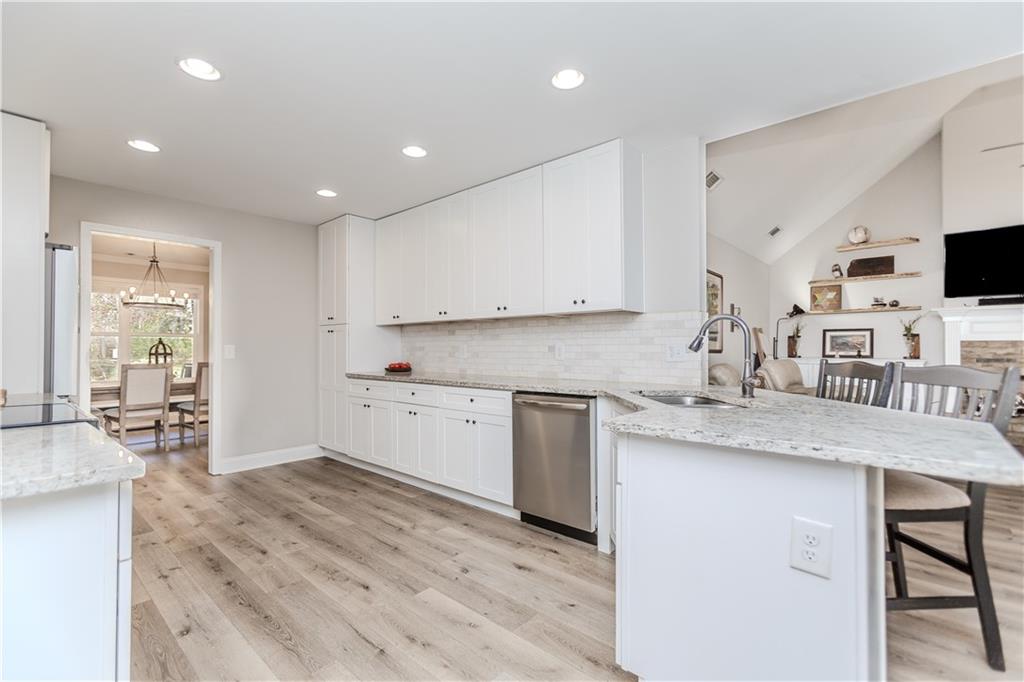 43 Water Lily Way Pendergrass, GA 30567 - Photo 14 of 71 a kitchen with stainless steel appliances granite countertop a sink stove and cabinets