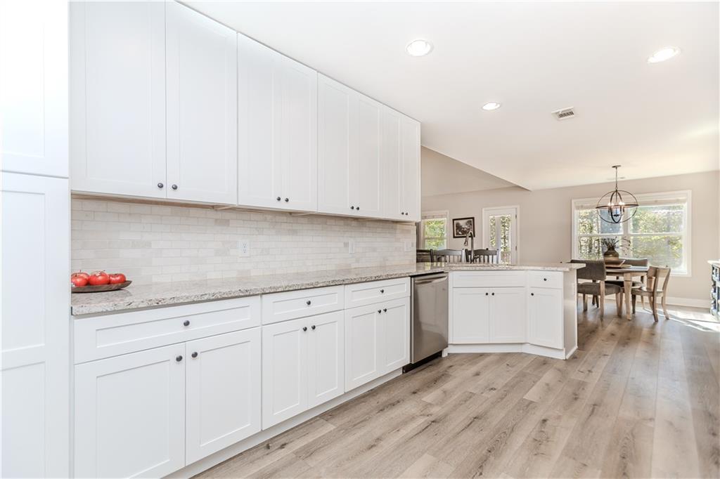 43 Water Lily Way Pendergrass, GA 30567 - Photo 15 of 71 a kitchen with granite countertop white cabinets and white appliances