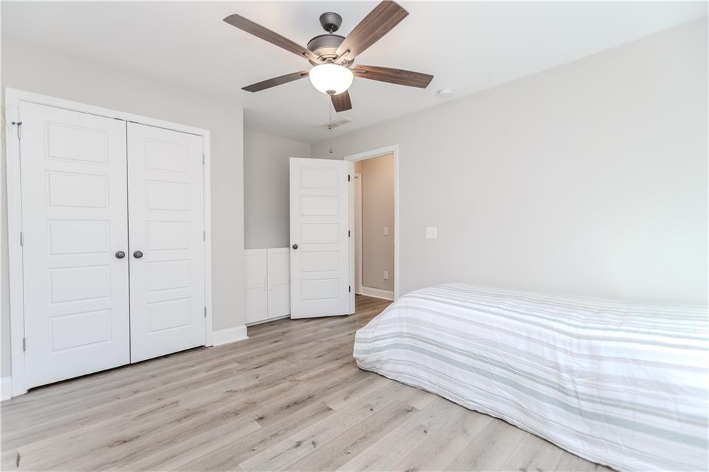 43 Water Lily Way Pendergrass, GA 30567 - Photo 21 of 71 a bedroom with a bed and a ceiling fan