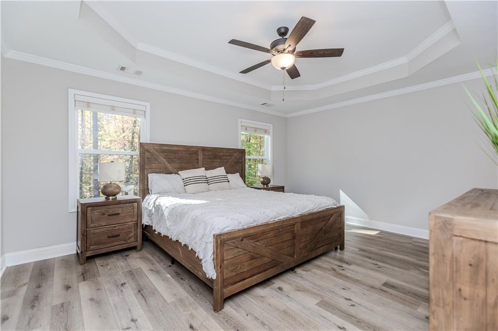 43 Water Lily Way Pendergrass, GA 30567 - Photo 22 of 71 a bedroom with a bed chandelier and a window