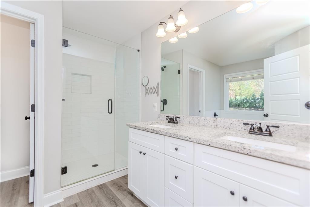 43 Water Lily Way Pendergrass, GA 30567 - Photo 24 of 71 a bathroom with a granite countertop sink mirror and