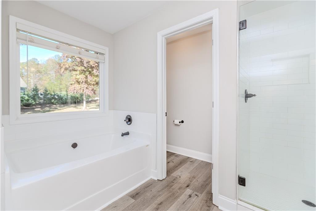 43 Water Lily Way Pendergrass, GA 30567 - Photo 25 of 71 a bathroom with a bathtub and a window