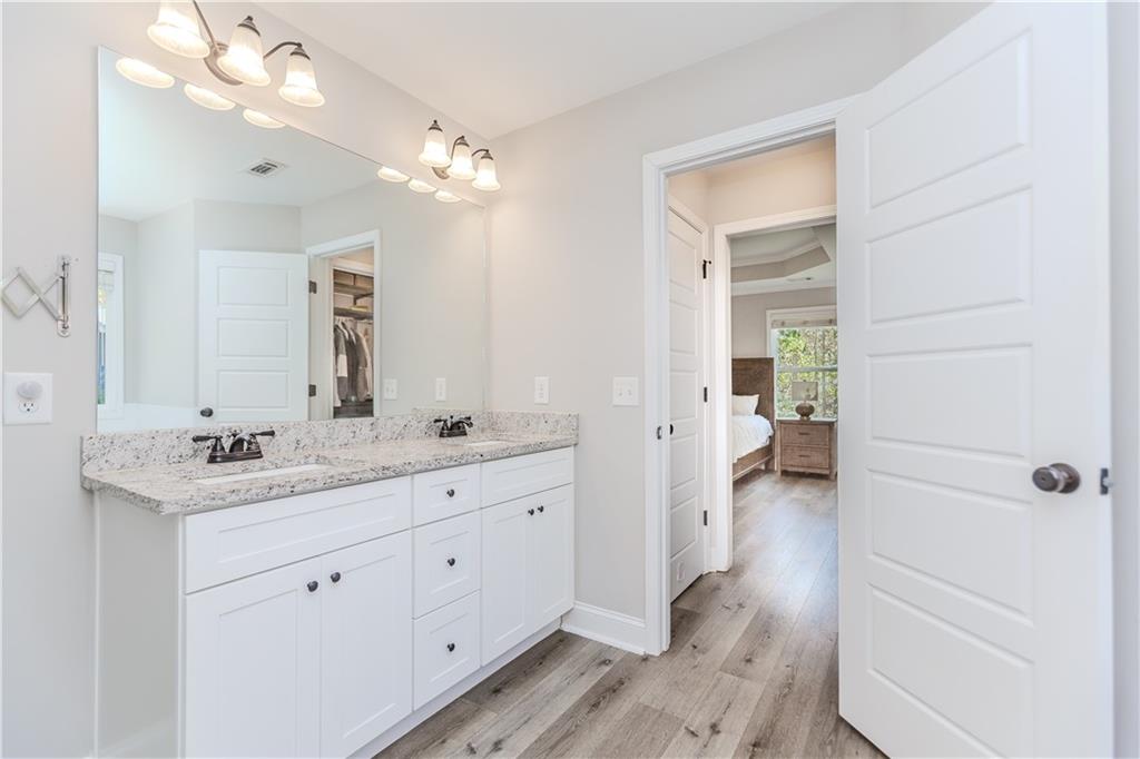 43 Water Lily Way Pendergrass, GA 30567 - Photo 26 of 71 a spacious bathroom with a granite countertop sink a mirror and a shower