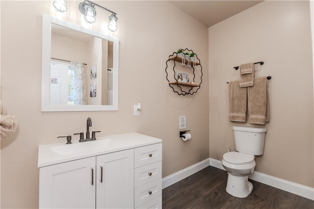 43 Water Lily Way Pendergrass, GA 30567 - Photo 39 of 71 a bathroom with a toilet a sink and mirror