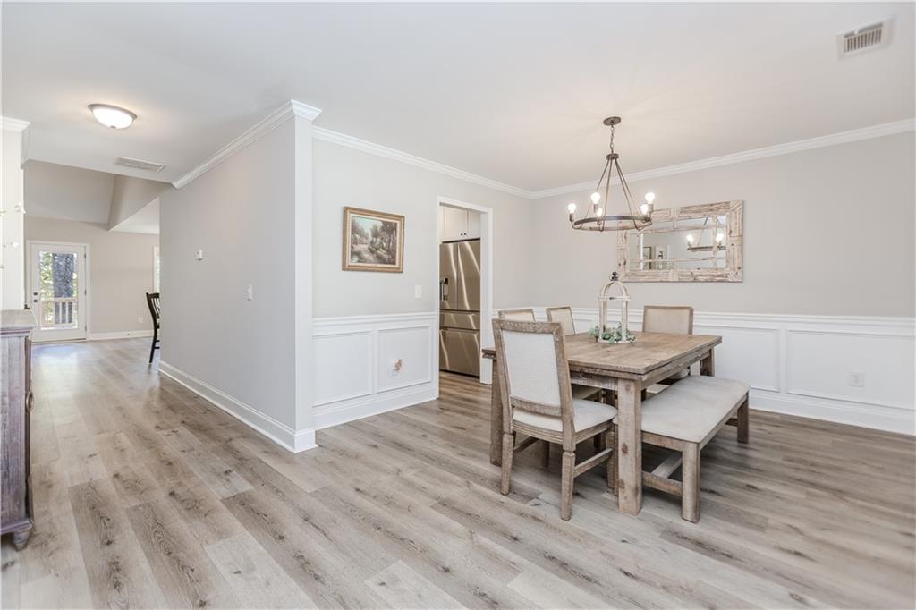 43 Water Lily Way Pendergrass, GA 30567 - Photo 6 of 71 a view of a dining room with furniture and wooden floor