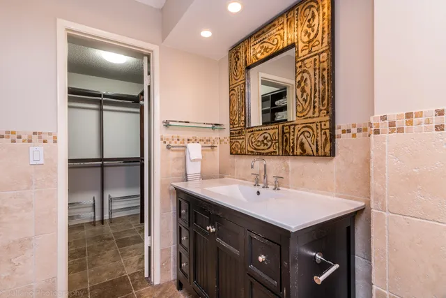 a bathroom with a sink a mirror and a shower