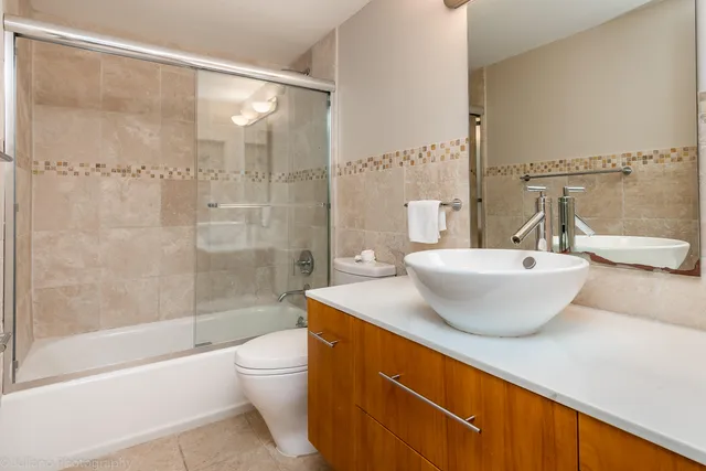a bathroom with a sink mirror toilet and bathtub