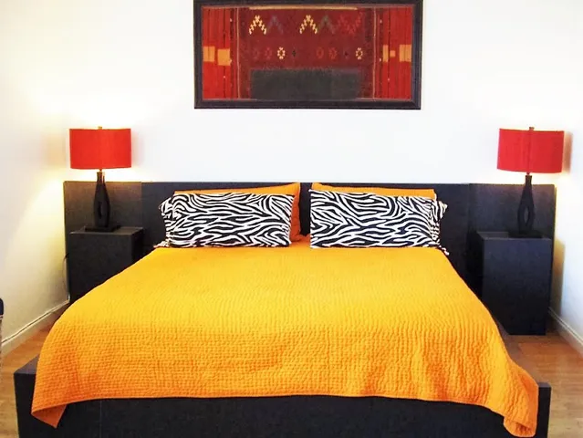 a bedroom with a bed and dresser