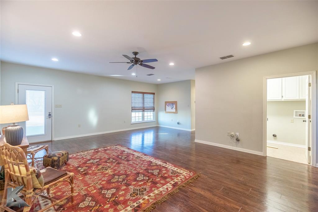 1198 Iberis Road South, Unit B Tuscola, TX 79562 - Photo 16 of 40 a view of a livingroom with wooden floor and a flat screen tv