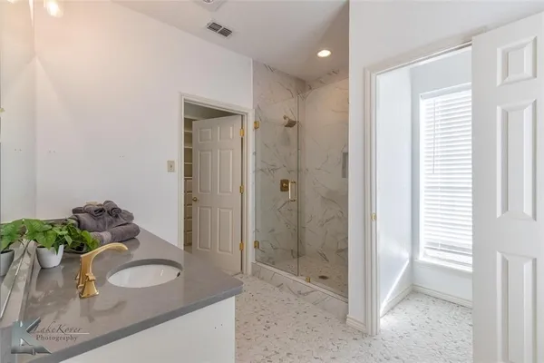 a bathroom with a sink vanity and mirror