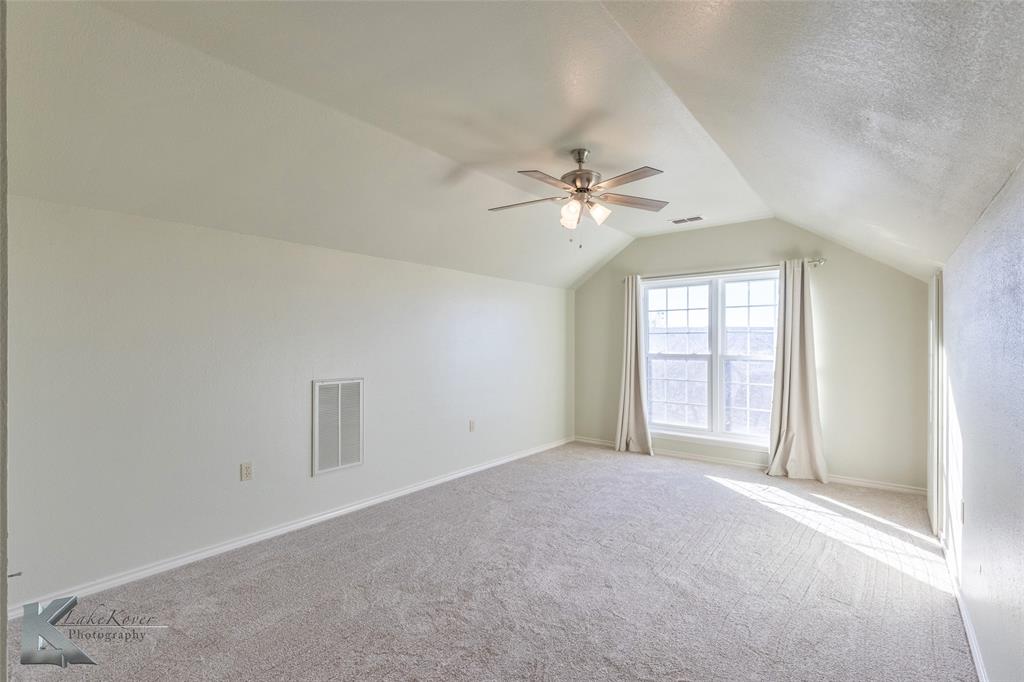 1198 Iberis Road South, Unit B Tuscola, TX 79562 - Photo 35 of 40 an empty room with windows and chandelier fan