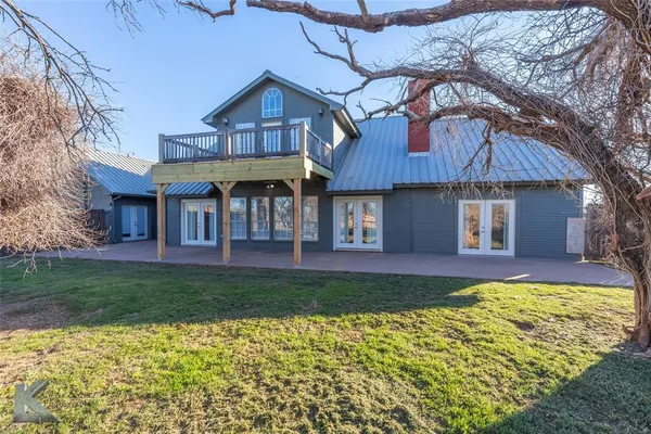 a view of a backyard with wooden fence