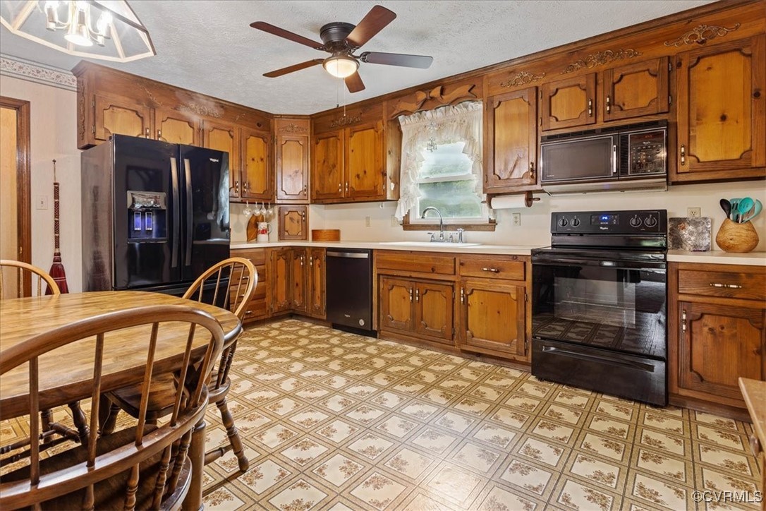 3528 Maple Ridge Lane Hopewell, VA 23860 - Photo 14 of 29 a kitchen with stainless steel appliances granite countertop a stove a sink dishwasher and a refrigerator with wooden cabinets
