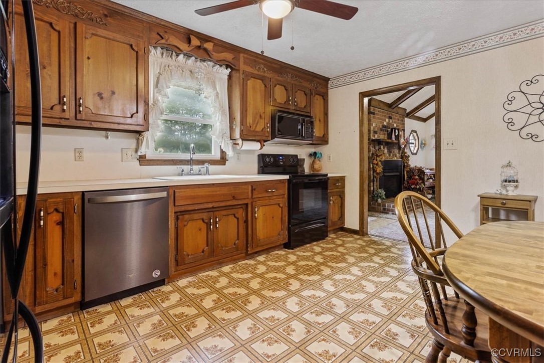 3528 Maple Ridge Lane Hopewell, VA 23860 - Photo 16 of 29 a kitchen with stainless steel appliances granite countertop a stove top oven a sink a dining table and chairs with wooden floor