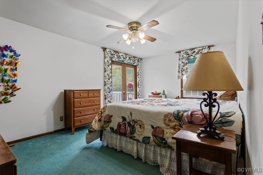 3528 Maple Ridge Lane Hopewell, VA 23860 - Photo 20 of 29 a bedroom with a bed and a chandelier