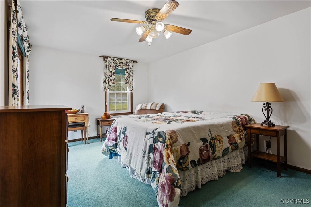 3528 Maple Ridge Lane Hopewell, VA 23860 - Photo 21 of 29 a bedroom with a bed and a chandelier