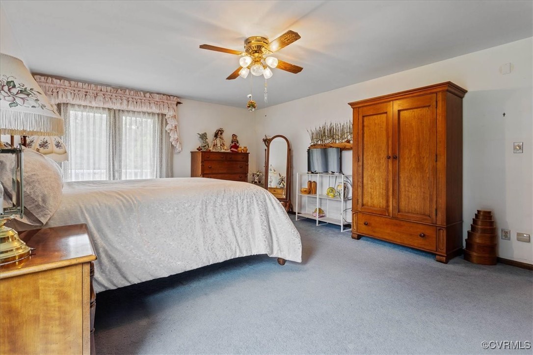 3528 Maple Ridge Lane Hopewell, VA 23860 - Photo 22 of 29 a bedroom with a bed and a chandelier