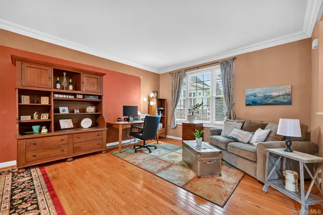 a living room with furniture a rug and a large window