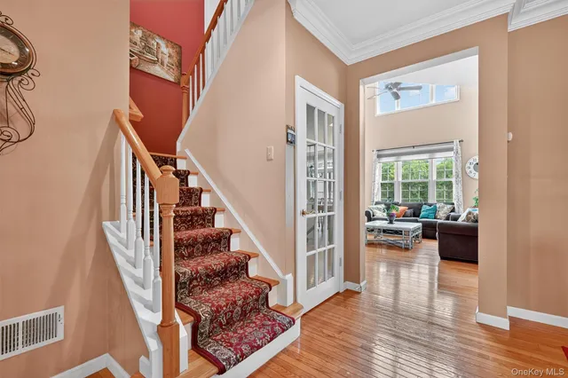 a view of entryway and hall with wooden floor