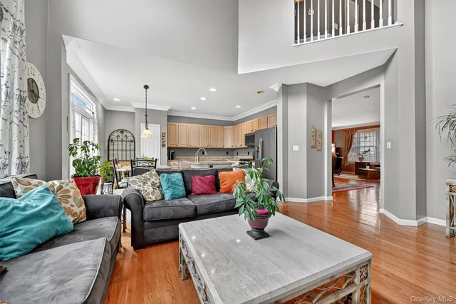 a living room with furniture and kitchen view