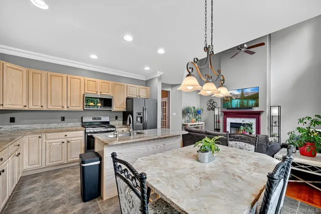 a kitchen that has a stove a table and chairs in it