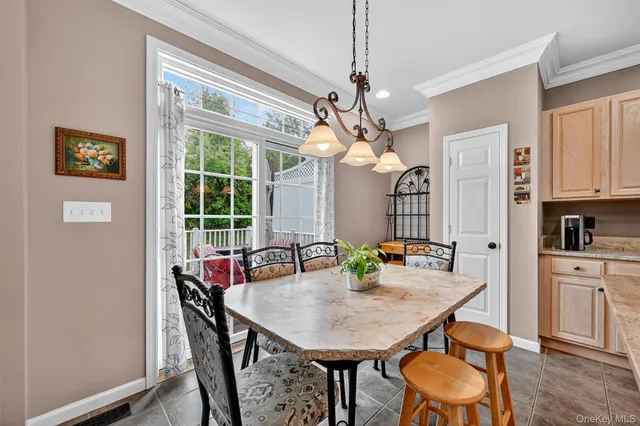 a kitchen with sink refrigerator dining table and chairs