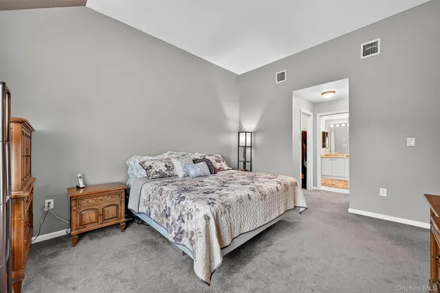 a bed room with a bed and a chair