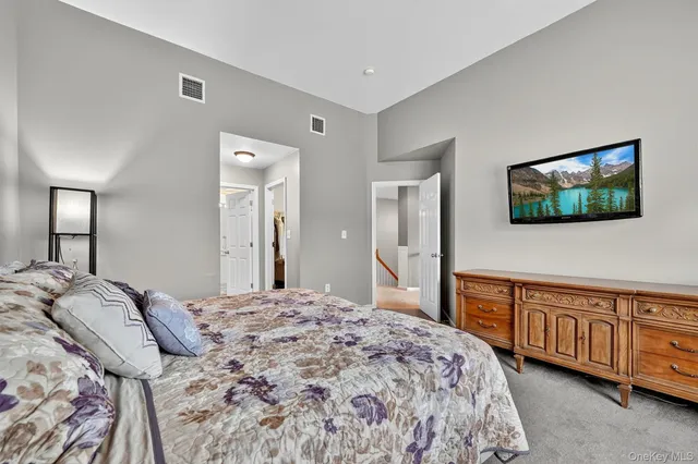 a bedroom with a bed and a lamp with the mirror