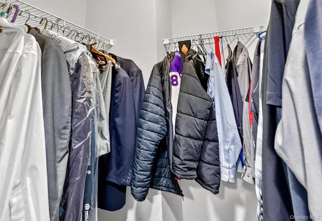 a spacious bathroom with a granite countertop sink a toilet and a mirror