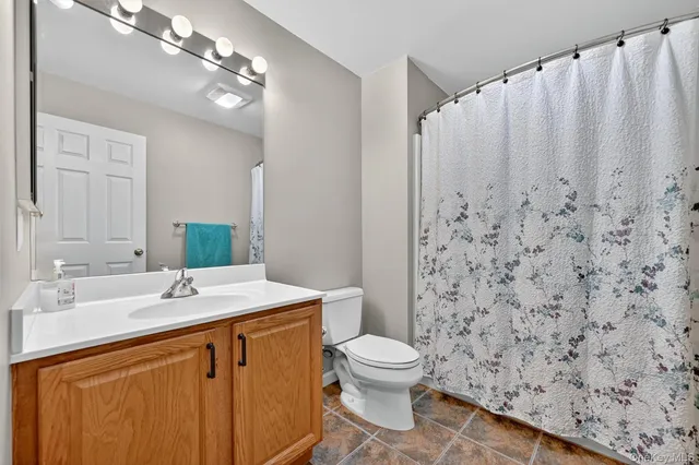 a view of walk in closet with clothes