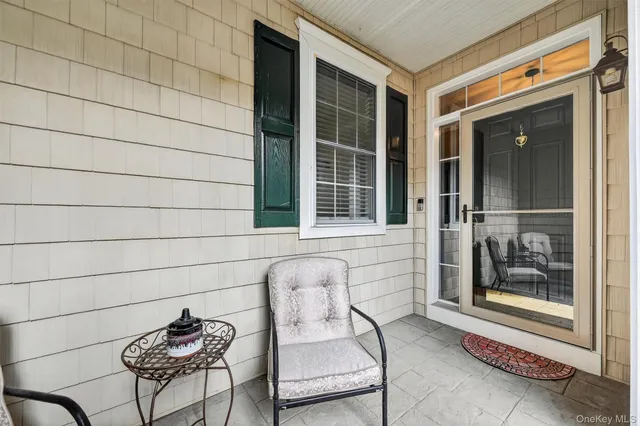 a front view of a house with outdoor seating