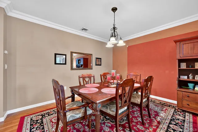 a dining room with furniture and chandelier